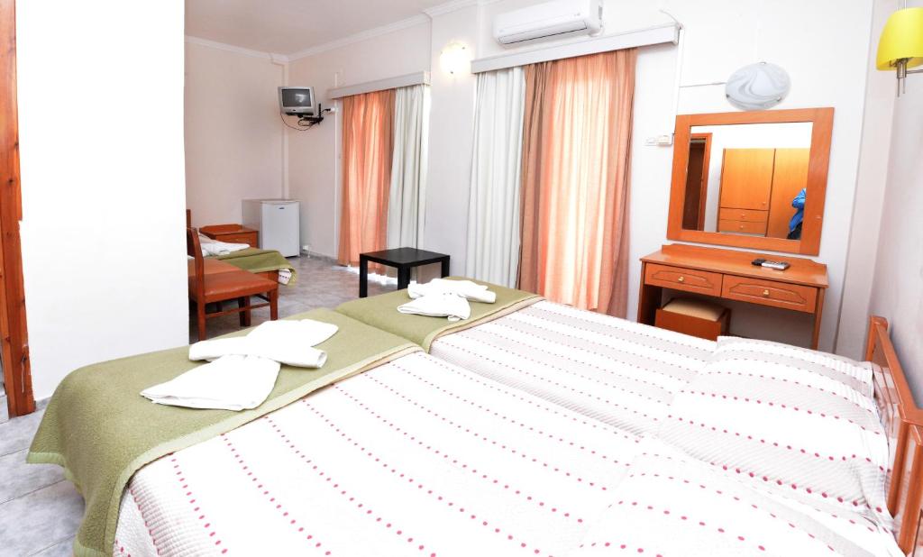 Łóżko lub łóżka w pokoju w obiekcie Veroniki Hotel