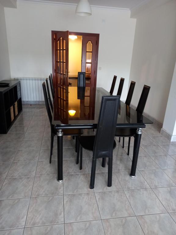 Casa do Olival في فيلا فلور: طاولة غرفة الطعام مع كراسي سوداء حولها