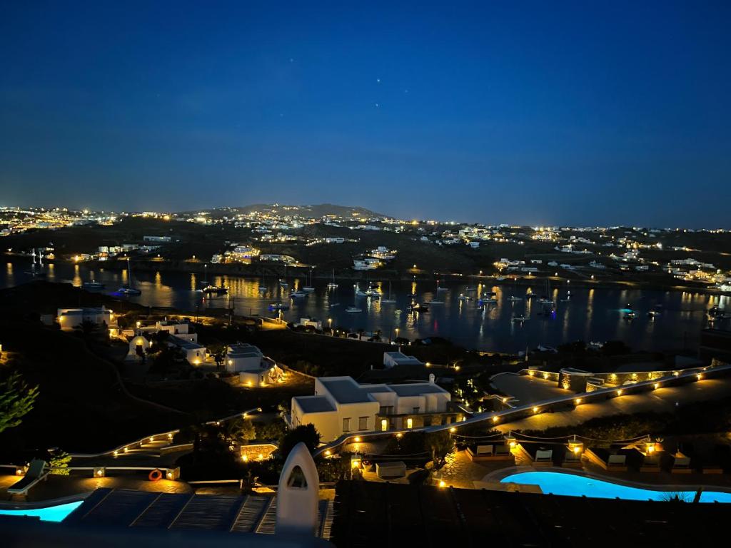 a view of a city at night at Navy Blue Suites in Ornos