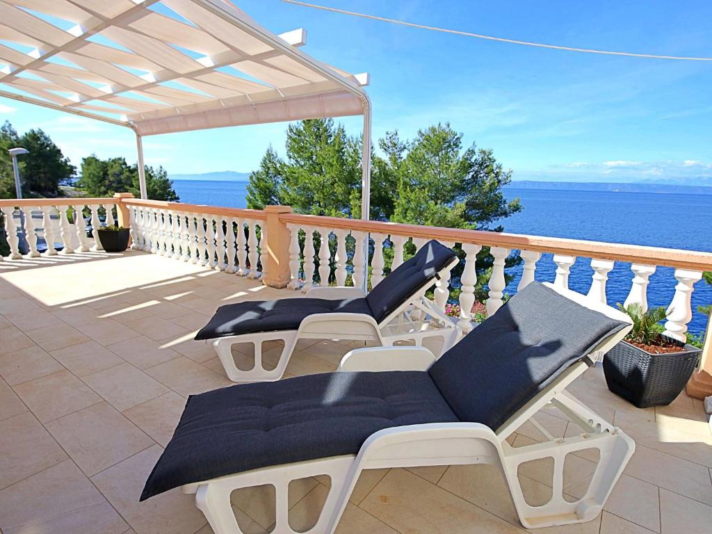 patio z 2 krzesłami i stołem na balkonie w obiekcie Holiday Home Anderson by Interhome w mieście Prigradica