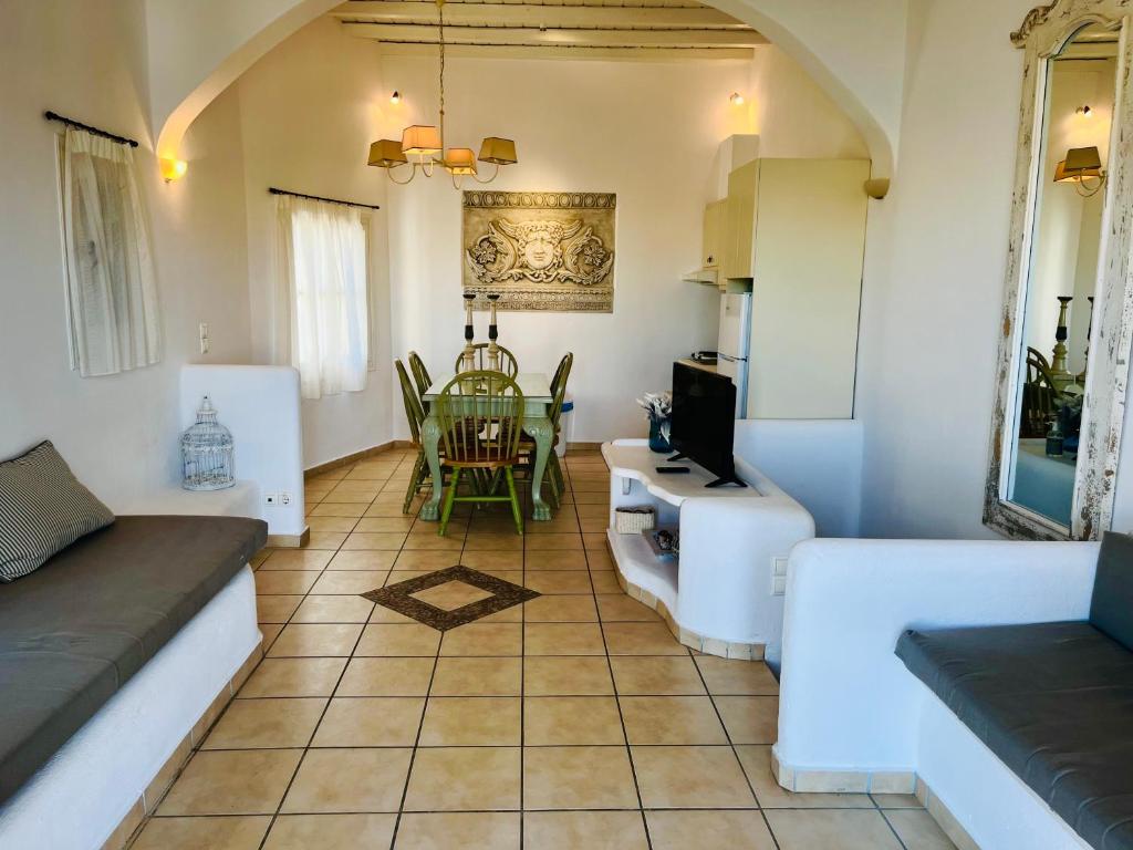 a living room with a couch and a table at Navy Blue Suites in Ornos