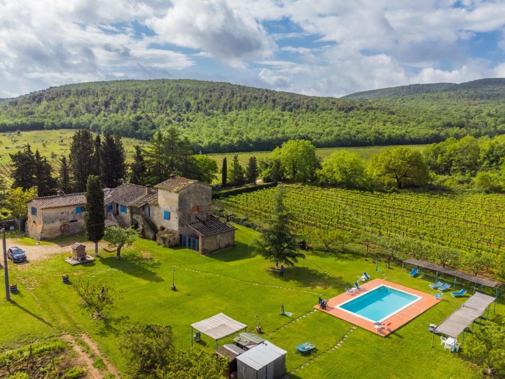an aerial view of a house in a vineyard with a swimming pool at Apartment Fattoria Petraglia - Padronale by Interhome in Monteriggioni