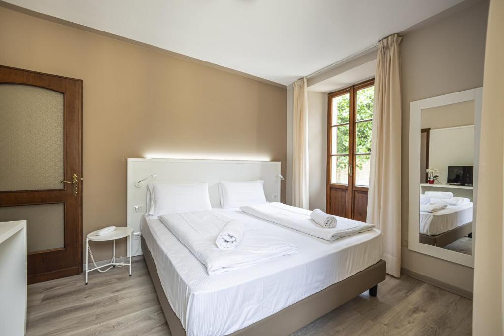 Postel nebo postele na pokoji v ubytování Hotel Il Portico by LVG Hotel Collection
