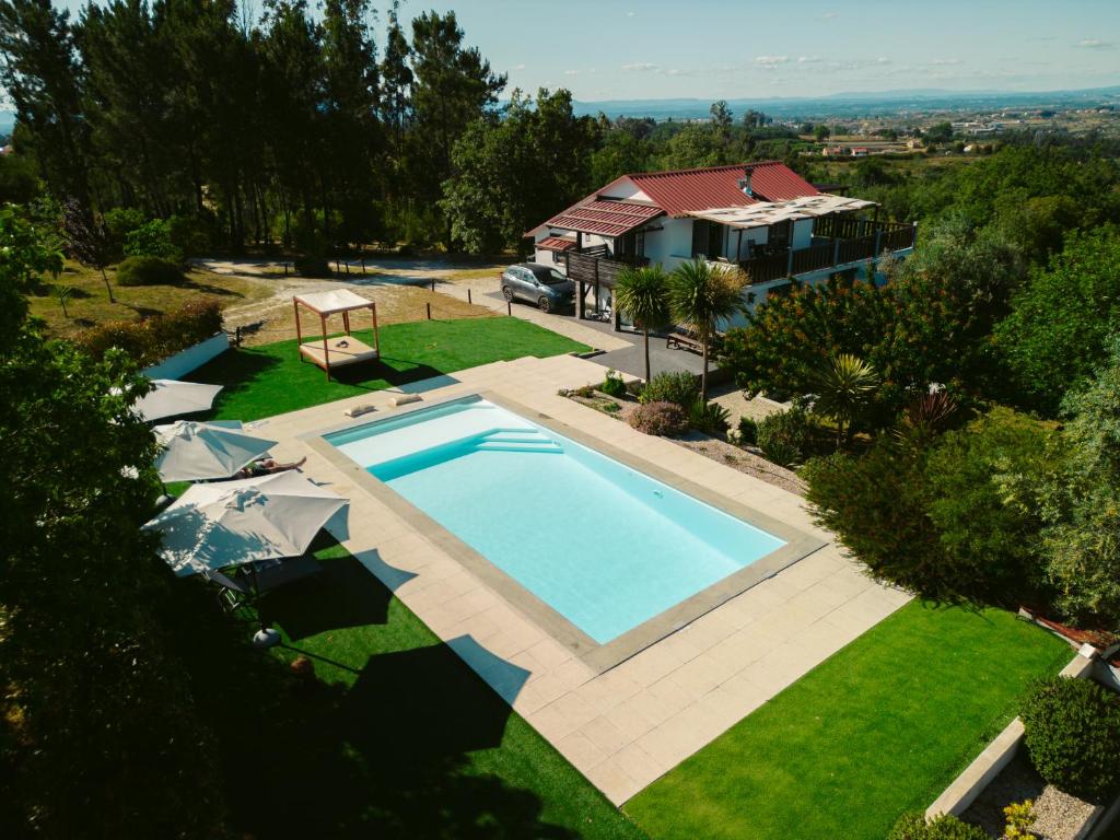 an overhead view of a swimming pool in front of a house at Pura - Home in Nature in Oliveira do Hospital