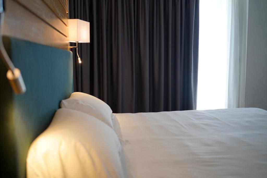 Posteľ alebo postele v izbe v ubytovaní PM Hotel