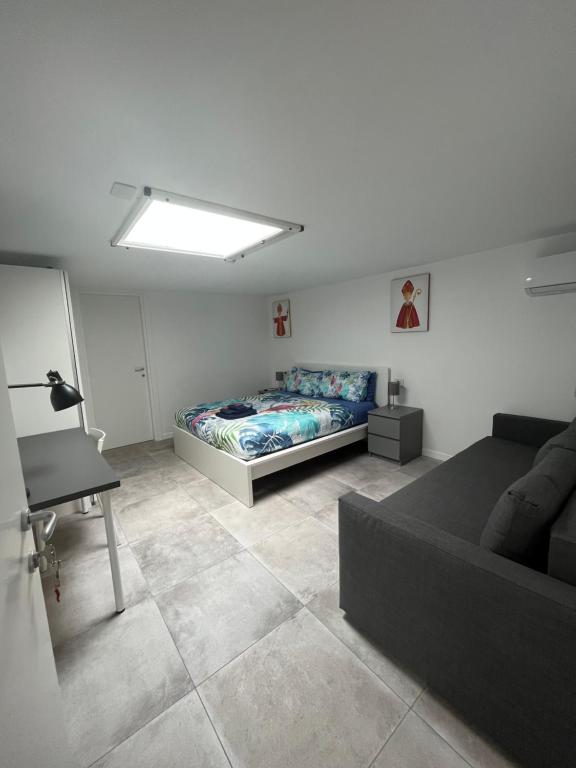 a living room with a bed and a couch at Lucullo's Rooftop in Naples