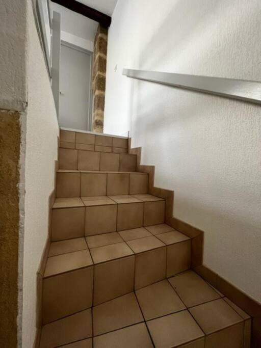 a staircase in a room with a stair case at #Le Rue des 2 Porches #F2 avec Cours #HyperCentre in Brive-la-Gaillarde