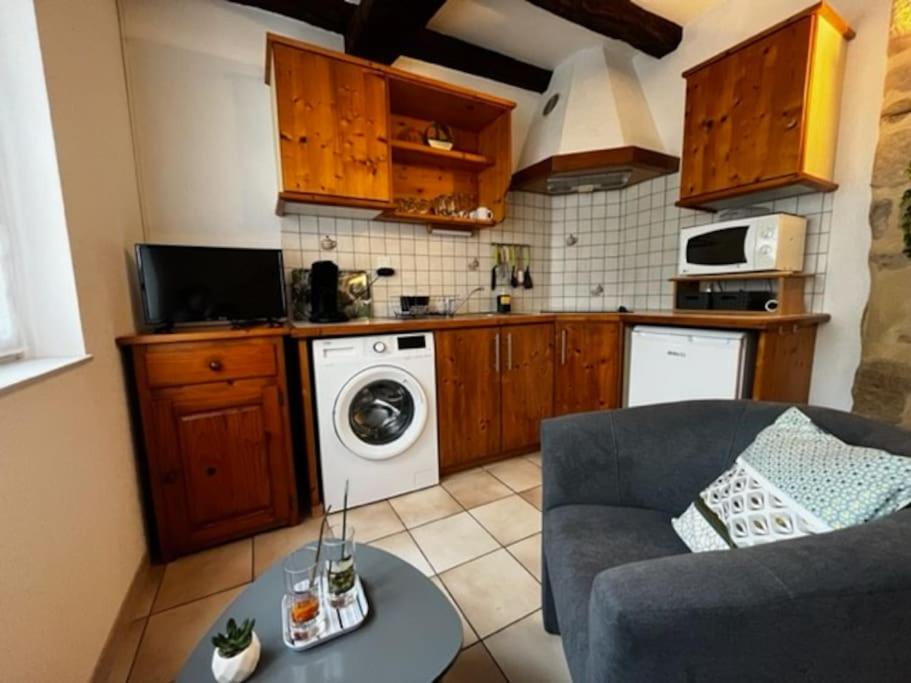 a kitchen with a couch and a washing machine at #Le Rue des 2 Porches #F2 avec Cours #HyperCentre in Brive-la-Gaillarde