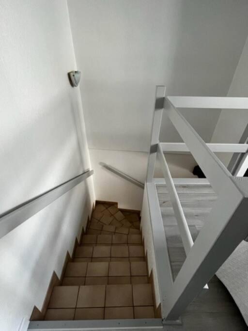 a staircase with a glass door in a room at #Le Rue des 2 Porches #F2 avec Cours #HyperCentre in Brive-la-Gaillarde
