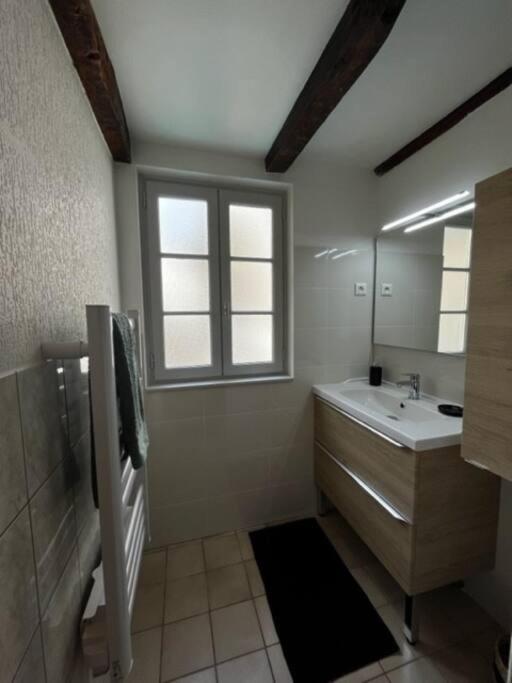 a bathroom with a tub and a sink and a window at #Le Rue des 2 Porches #F2 avec Cours #HyperCentre in Brive-la-Gaillarde