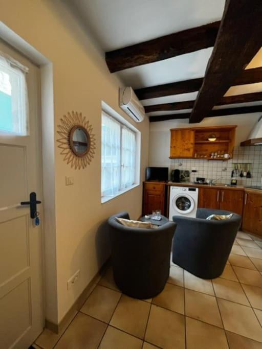 a kitchen with two stools in the middle of a room at #Le Rue des 2 Porches #F2 avec Cours #HyperCentre in Brive-la-Gaillarde