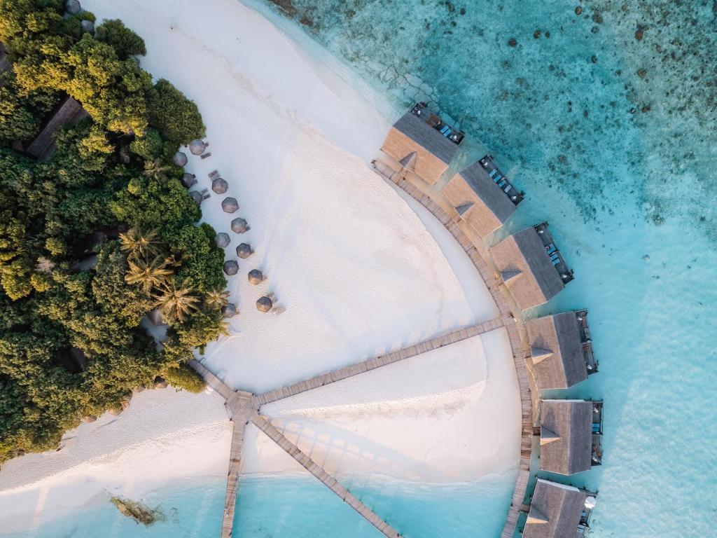 an aerial view of a beach with a pier at Reethi Beach Resort in Baa Atoll