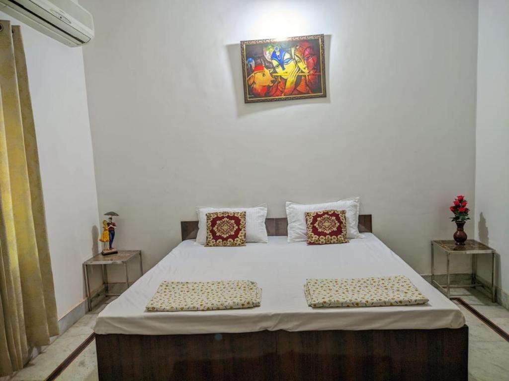 a bedroom with a bed with two pillows on it at Kridha holidays homestay with kitchen in Vrindāvan