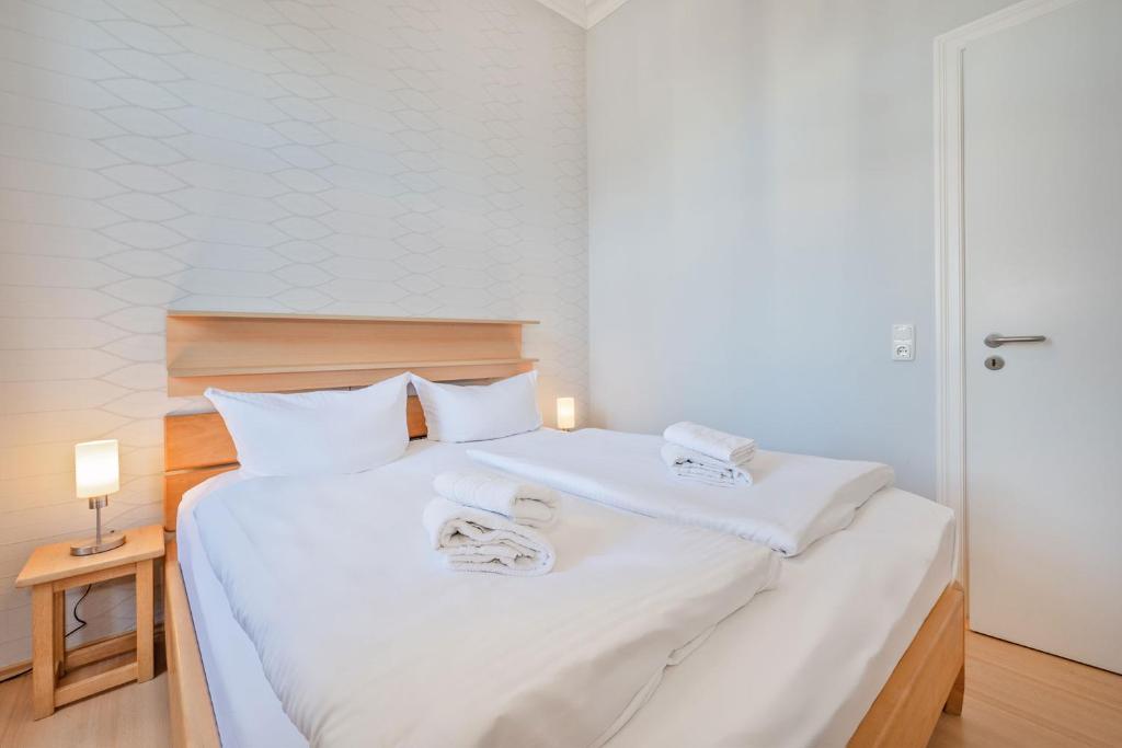 Postel nebo postele na pokoji v ubytování Villa Vineta Wohnung 203
