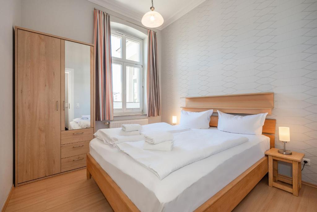Postel nebo postele na pokoji v ubytování Villa Vineta Wohnung 203