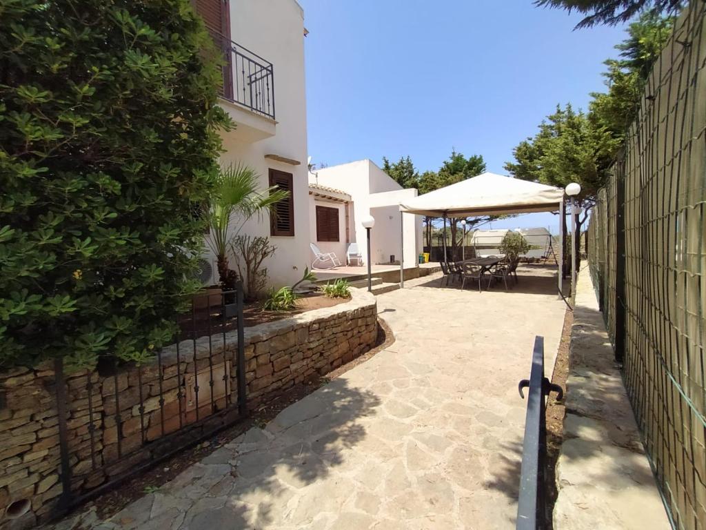 a courtyard of a house with a fence at SanVitoTour- Residence Il Baglio in San Vito lo Capo