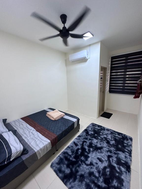 a bedroom with a bed and a ceiling fan at Fiyyadh Homestay Gambang in Gambang