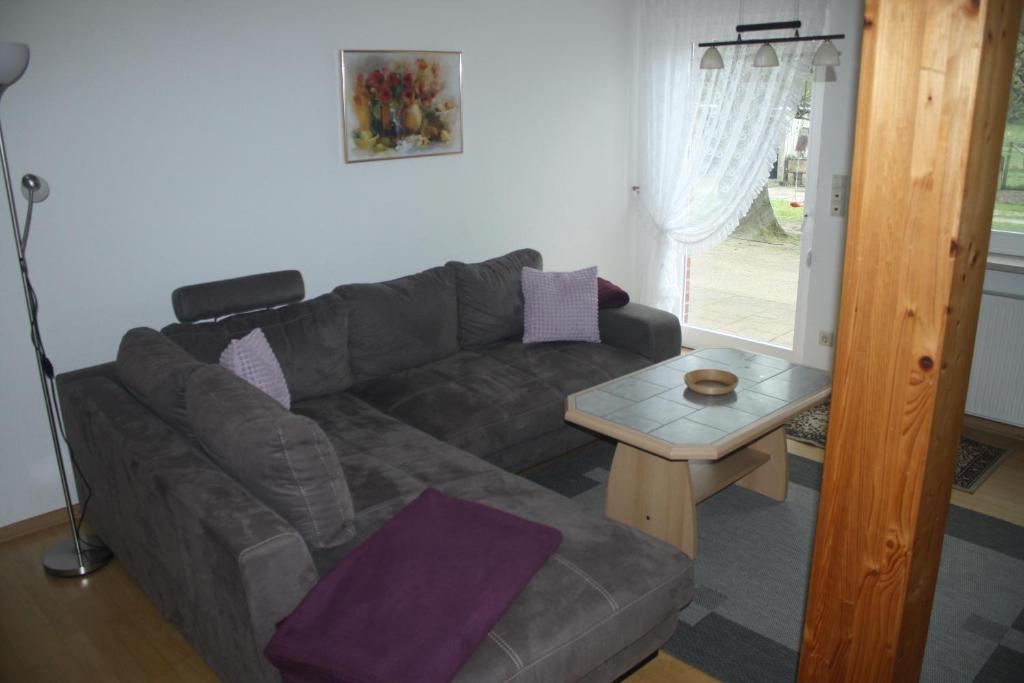 a living room with a couch and a table at Ferienwohnung Zum Schwalbennest in Eimke