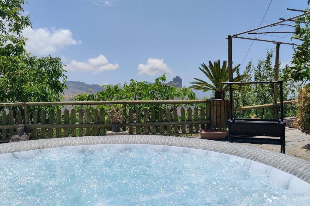 a hot tub in a backyard with a fence at La Cabañita in Las Palmas de Gran Canaria