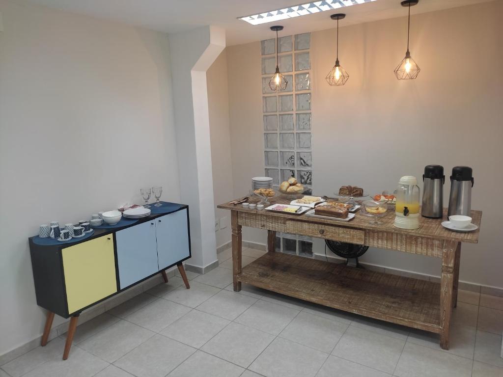 a kitchen with a table with food on it at Pousada Premiatto in Holambra