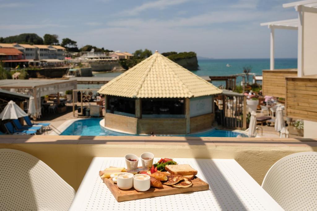 a plate of food sitting on a table on a balcony at Del Mare Beach Hotel in Sidari