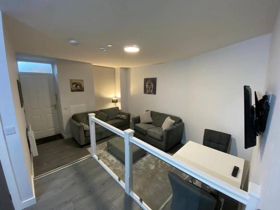 a living room with two couches and a table at Modern Apartment - Wick Harbour in Wick
