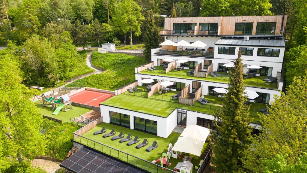 an aerial view of a house with a green roof at Hotel Kras in Jedovnice
