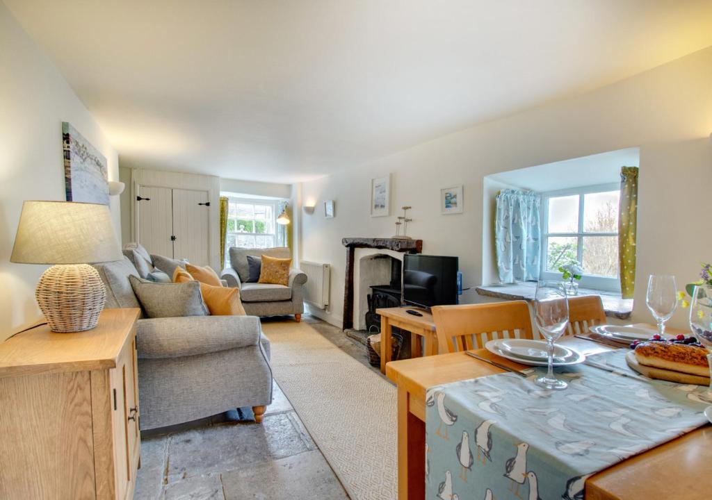 a living room with a couch and a table at The Arc in Swanage