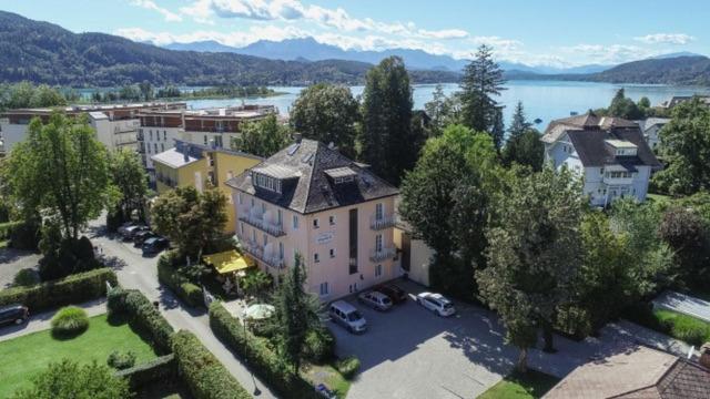 an aerial view of a large house with a parking lot at Villa Auguste in Pörtschach am Wörthersee