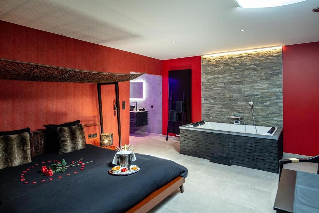 Nuits Blanches في لييج: غرفة نوم بسرير كبير وحوض استحمام