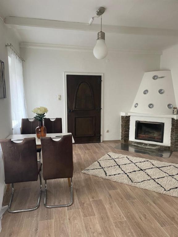 a living room with a table and a fireplace at Appartement Attergau in Sankt Georgen im Attergau