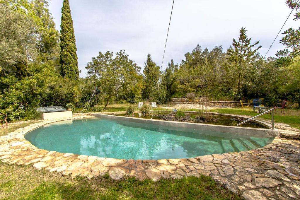 a swimming pool in the middle of a yard at Catalunya Casas Rural charm on an olive farm in Costa Dorada! in Vespella de Gaià 