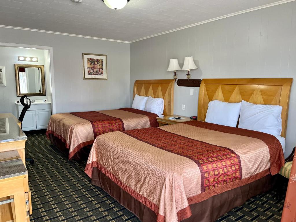 a hotel room with two beds in it at Chief Motel in Keokuk