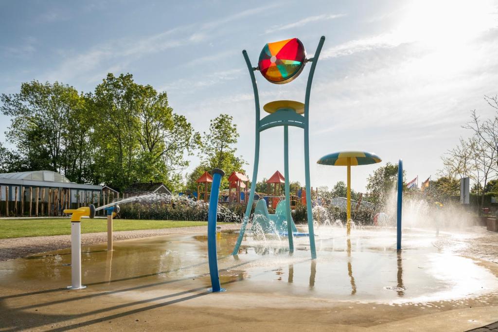 a water park with a playground with a fountain at Vakantiepark duinzicht in Koudekerke