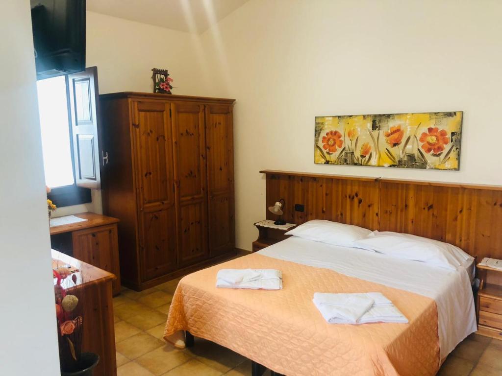 a bedroom with a bed with two towels on it at Agriturismo Valle di Chiaramonte in Chiaramonte Gulfi