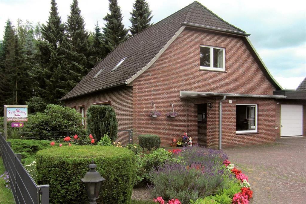 a brick house with a garden in front of it at Ferienwohnung Harms in Garlstorf