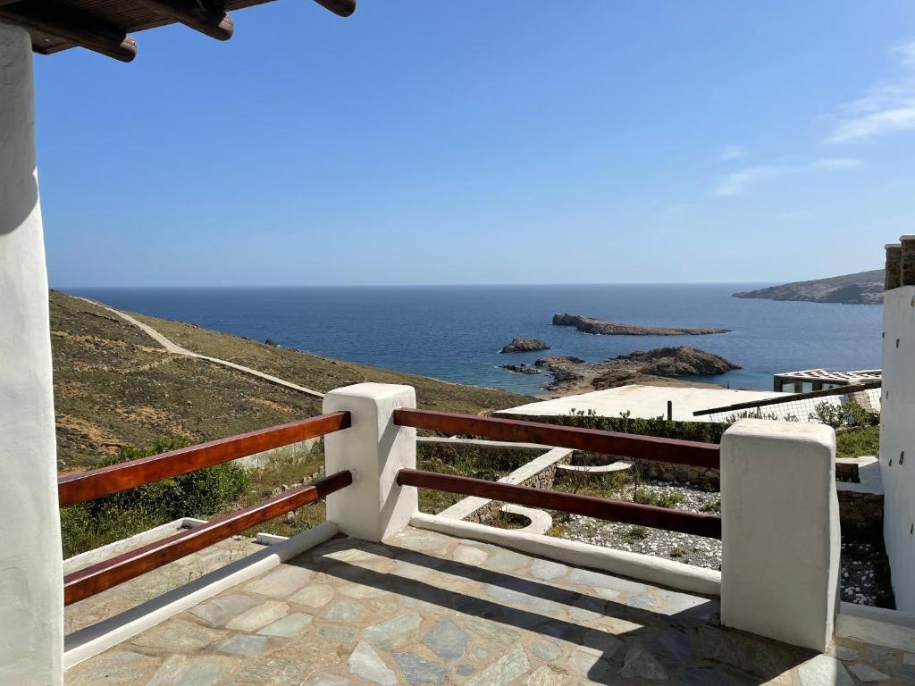 a view of the ocean from a balcony of a house at Cycladic style Maisonette with staggering sea view in Agios Sostis Mykonos