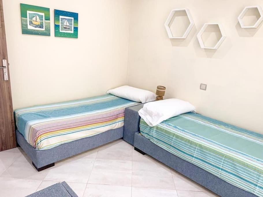 Postel nebo postele na pokoji v ubytování Océanica Marina Smir "avec accès piscine et une grande véranda"