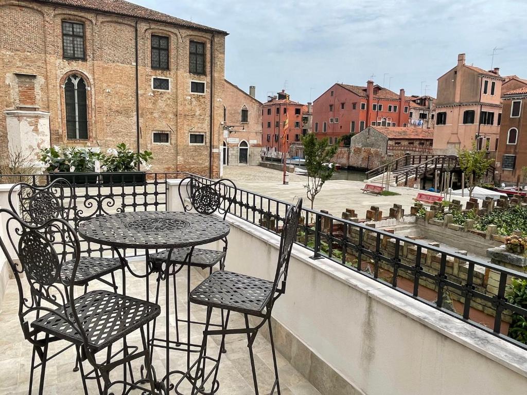 patio ze stołami i krzesłami na balkonie w obiekcie MH 3202 w Wenecji