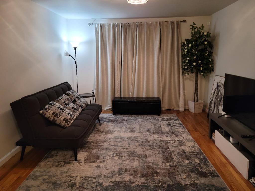 a living room with a couch and a television at Daphy Ruby Stays in Newark