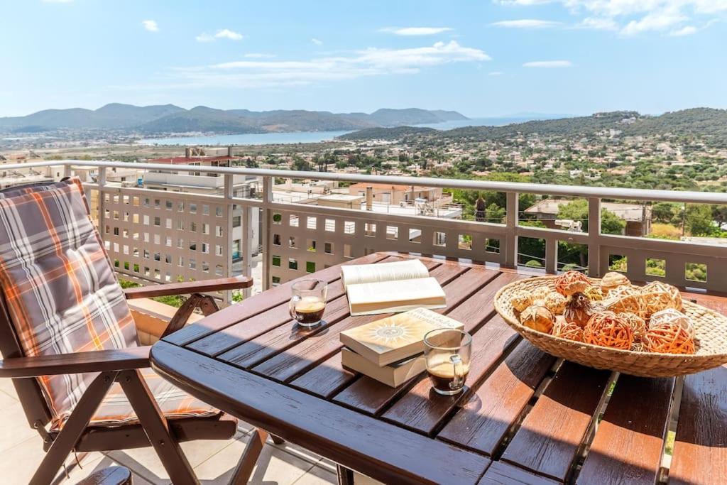 a wooden table with a basket of food on a balcony at 2 Bedroom Cozy apartment with Sea View and balcony in Anavissos