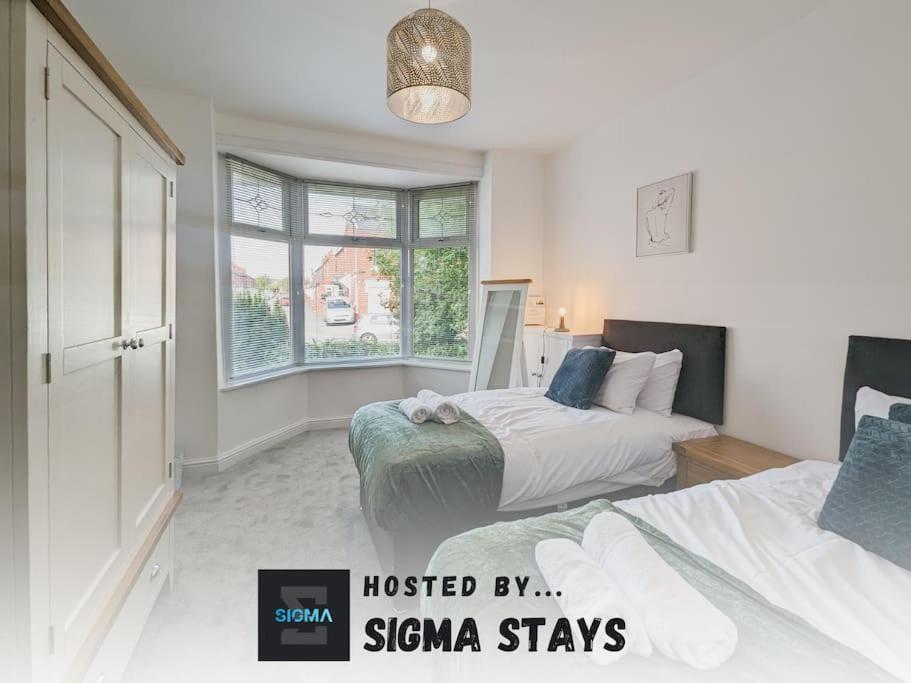 a bedroom with two beds and a window at Rose House - By Sigma Stays in Crewe