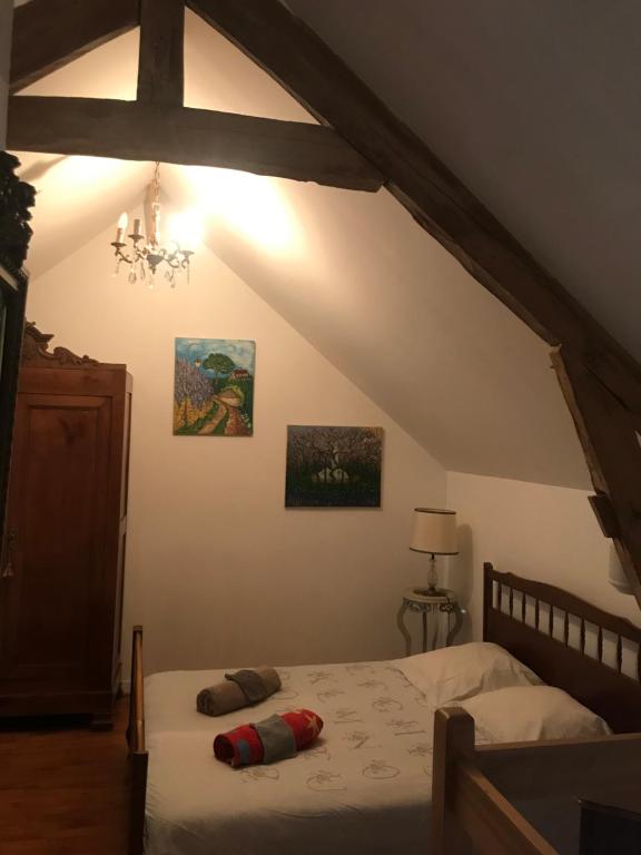a bedroom with a bed in a attic at Réveil aux chants des oiseaux in Assé-le-Riboul