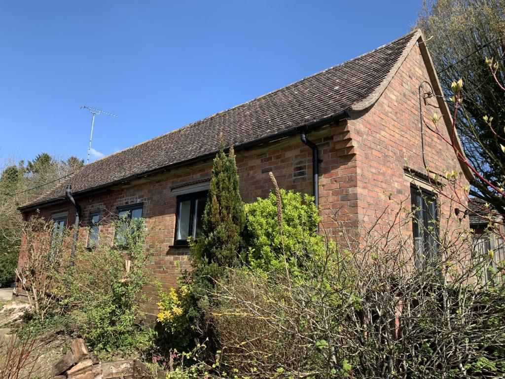 an old brick house with trees in front of it at The Old Exchange in Wimborne Minster