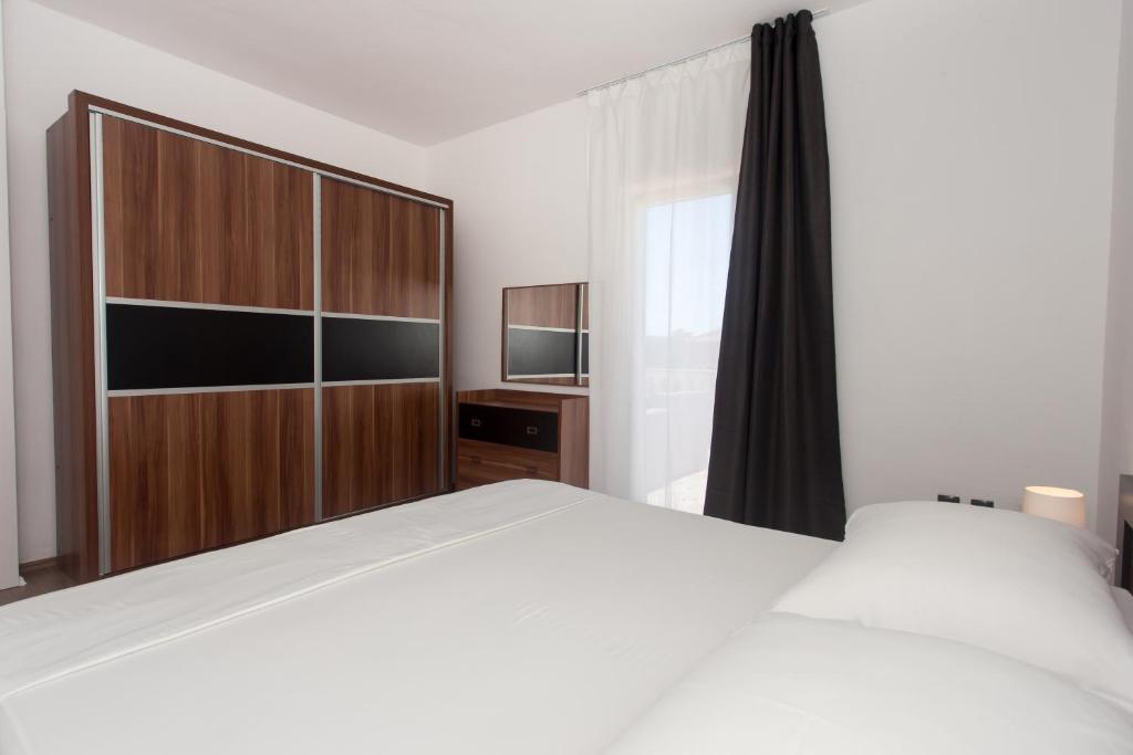 Posteľ alebo postele v izbe v ubytovaní Angolo Apartments
