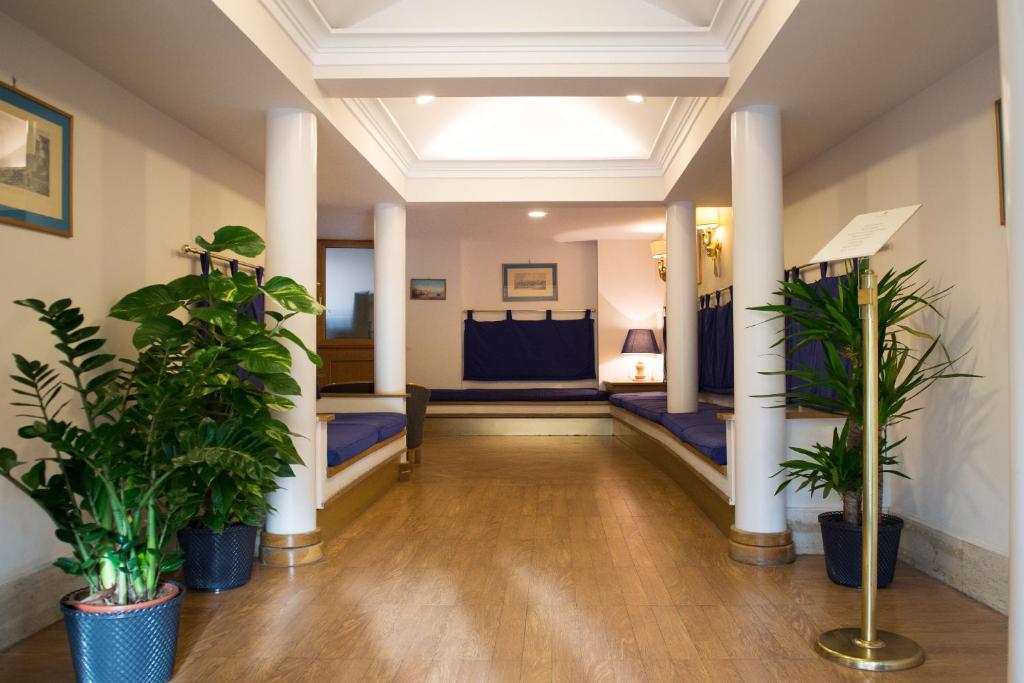 a hallway with potted plants in a room at Hotel Leopardi in Naples