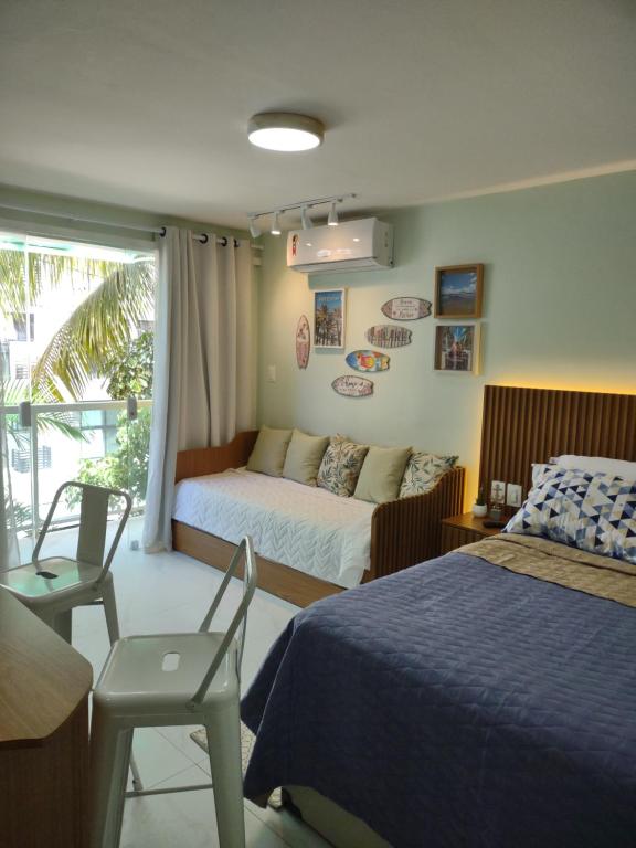 Ένα ή περισσότερα κρεβάτια σε δωμάτιο στο Perfeito Studio Praia