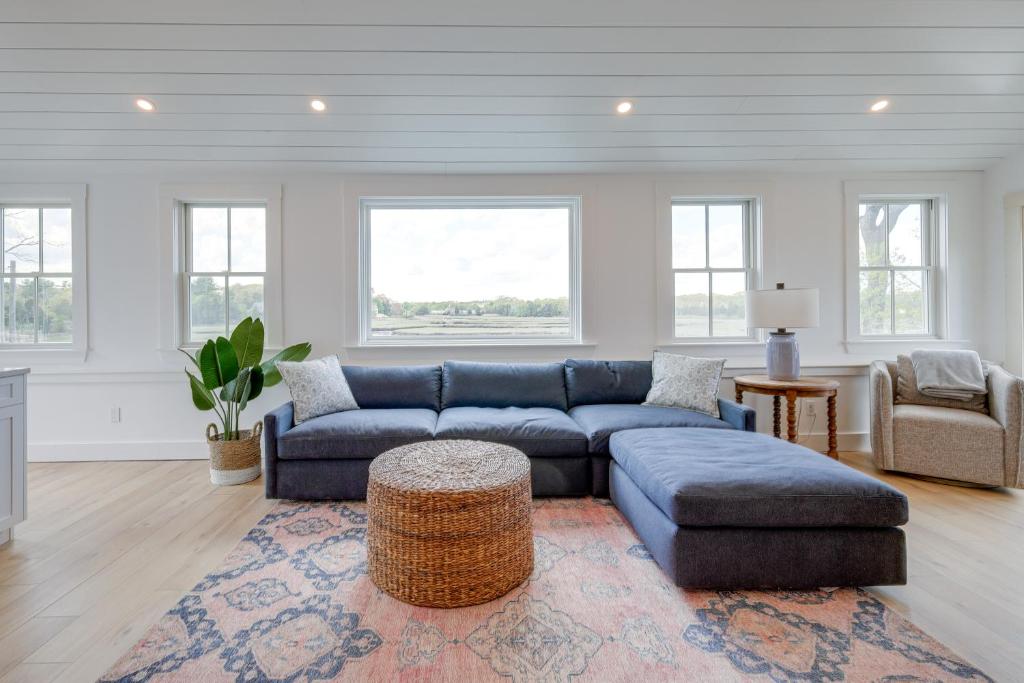 a living room with a blue couch and a rug at Unique Scituate Vacation Rental on Herring River! in Scituate