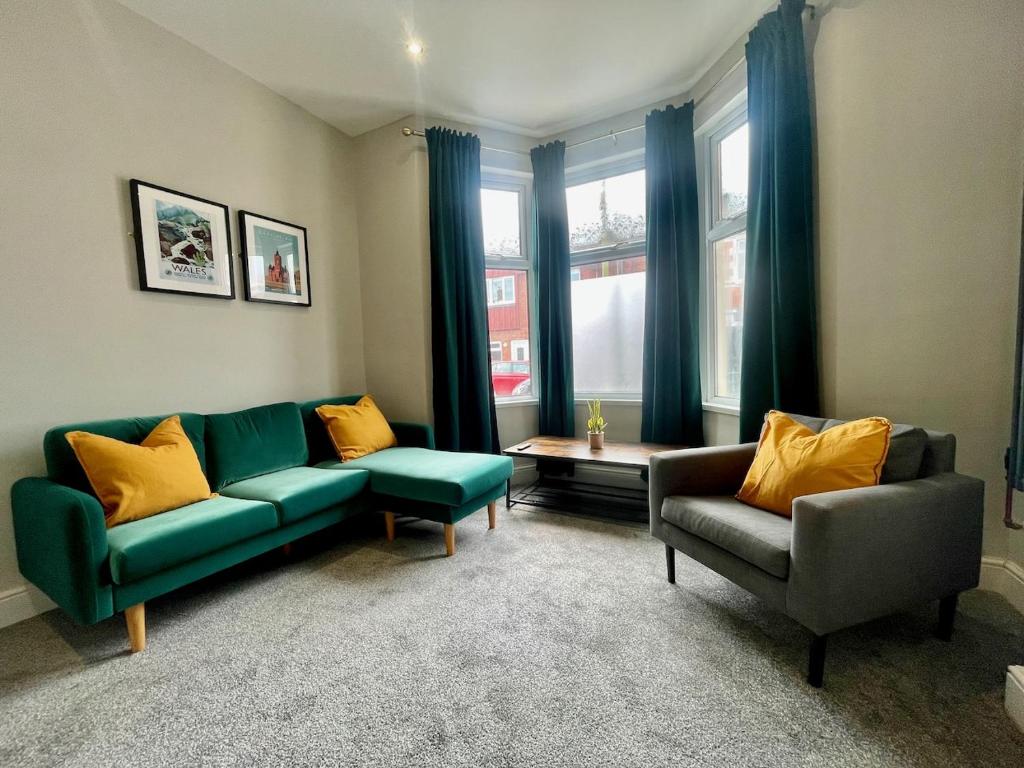 a living room with two couches and a table at 3 Bedroom Spacious House in Cardiff in Cardiff