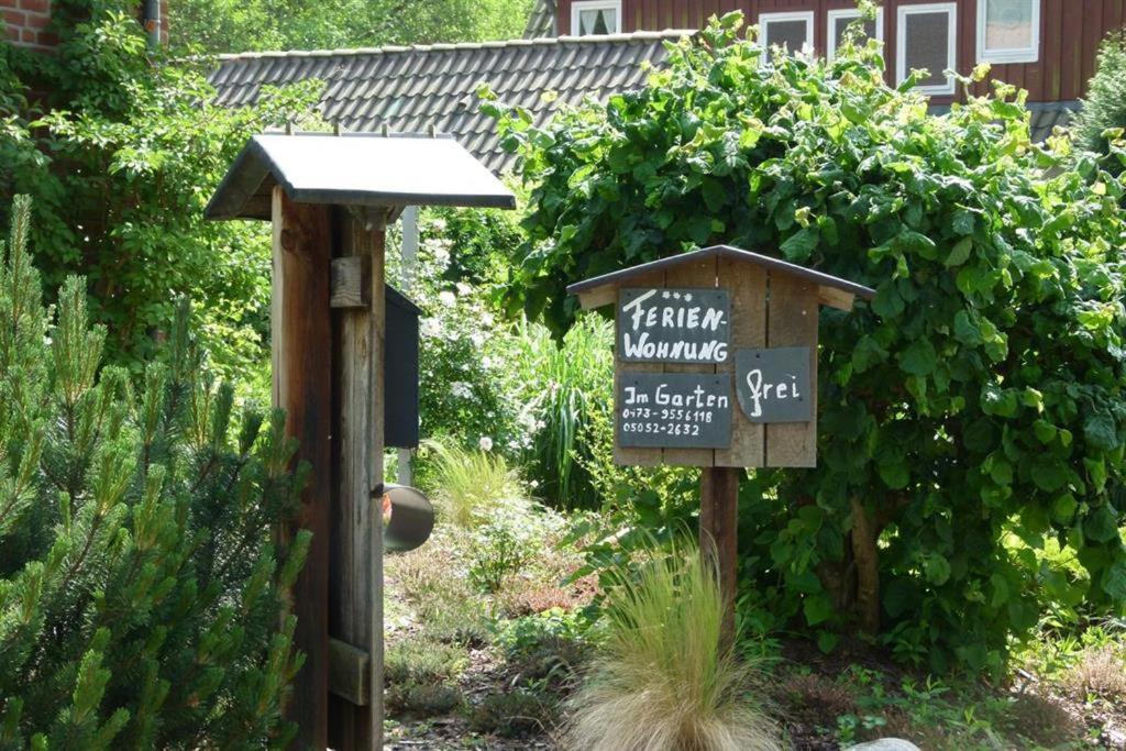 a sign in a garden with a gardenwarning sign at Adelheid Winkelmann in Hermannsburg